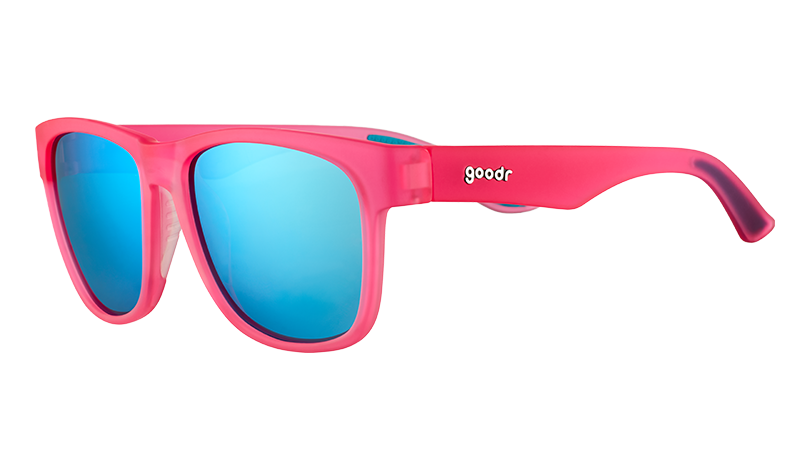 Three-quarter angle view of square-shaped, wide-fit pink sunglasses with blue reflective lenses.